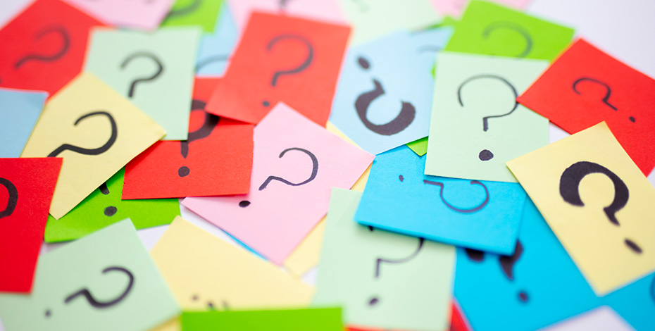 A series of colourful post-it notes with questions marks on them.