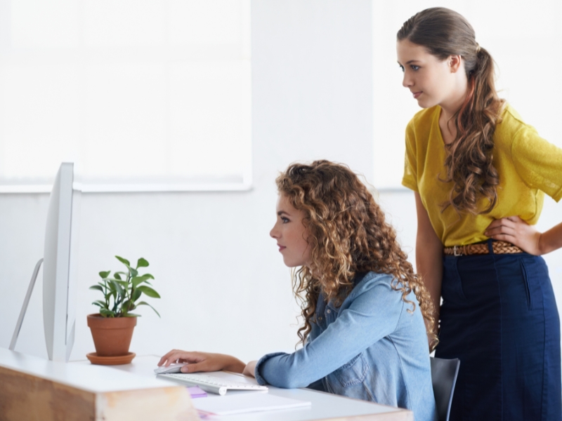 two females looking at computer