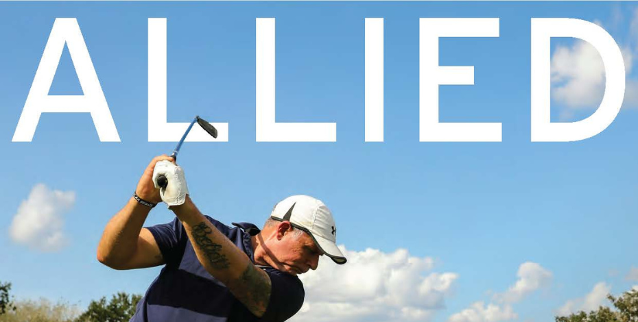 man swinging golf club