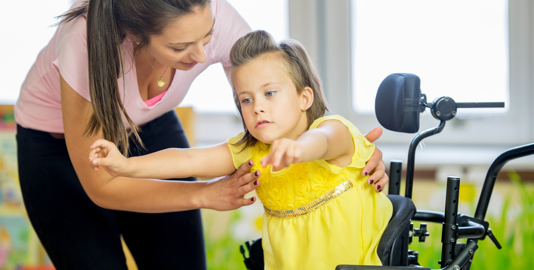 A child living with a disability working with their practitioner