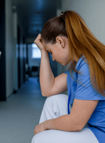 A woman clutching her head in pain