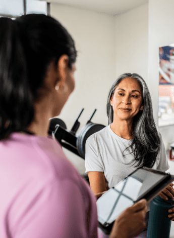 Physiotherapist talking to a client in a gym