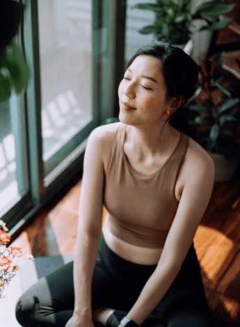 A woman smiling in a yoga class