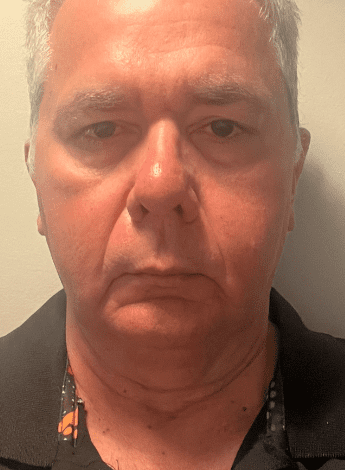The image is a close up of an older man's face