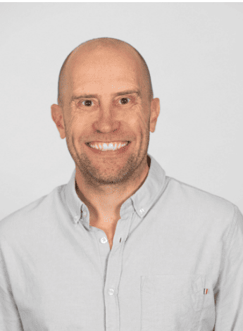 The image is of Professor Steve Kamper. He is bald and wearing a light coloured shirt. 