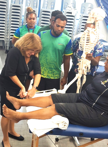 Maria Constantinou demonstrates an ankle joint mobilisation during the Sports Level 1 course in the Solomons. Photo: Solomon Islands National Institute of Sport.