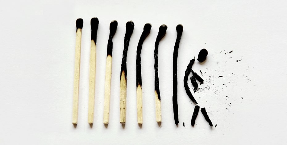 A series of increasingly burnt matches, the last looking like a person. 