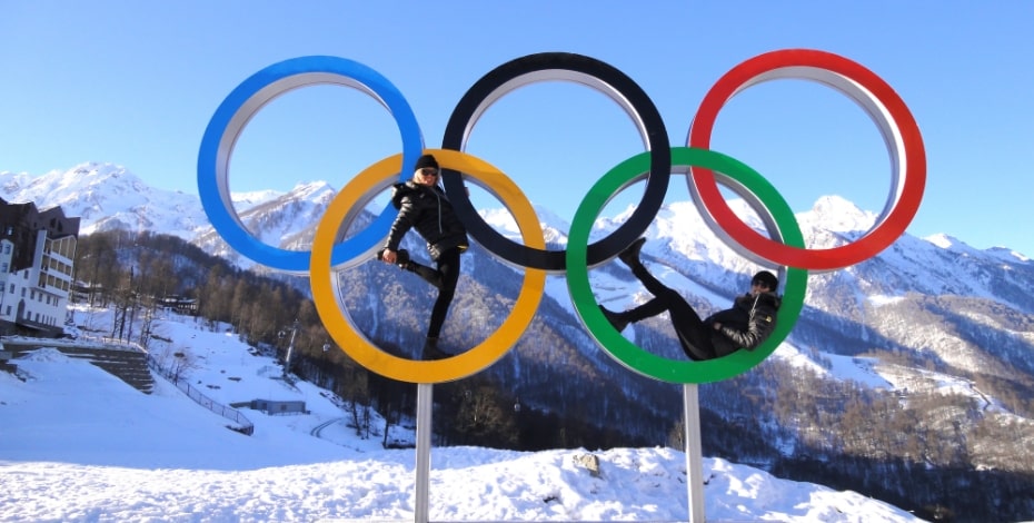 The Olympic Rings built large and on a mountain of snow in the alps.
