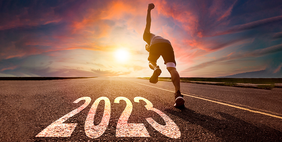 man runs on road with 2023 on road