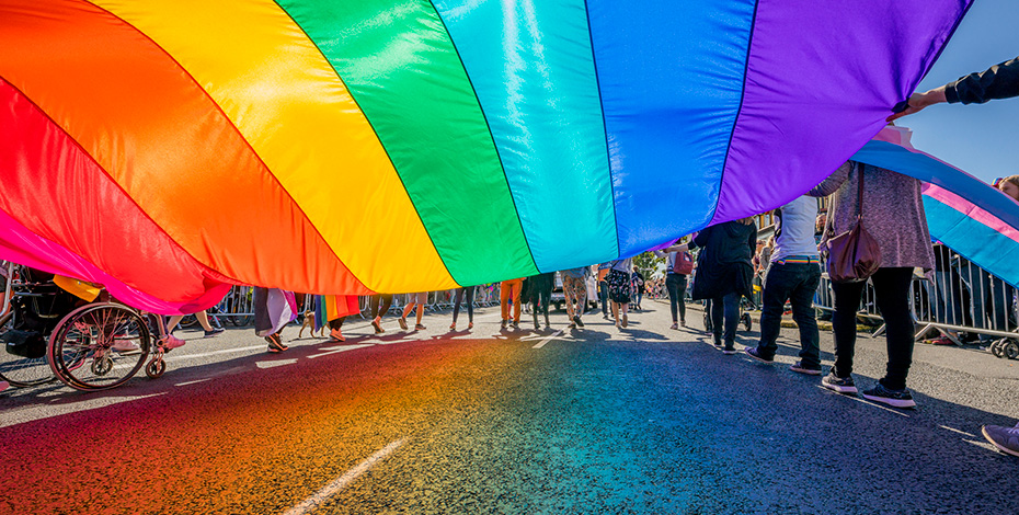 parade moves under rainbow flag 