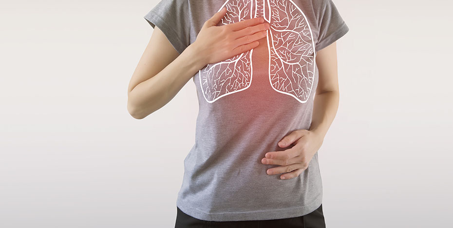 A woman breathing in with her lungs highlighted in red.