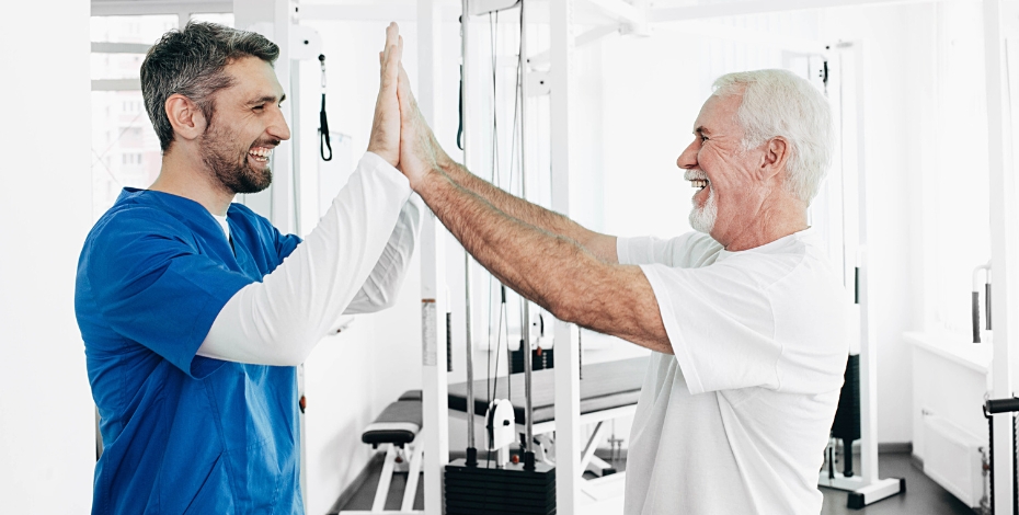 physio and patient doing a high five with both hands