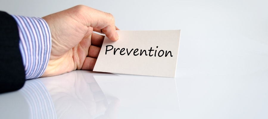 hand holding paper with the word prevention