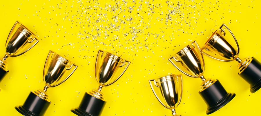 trophies with glitter on a yellow background