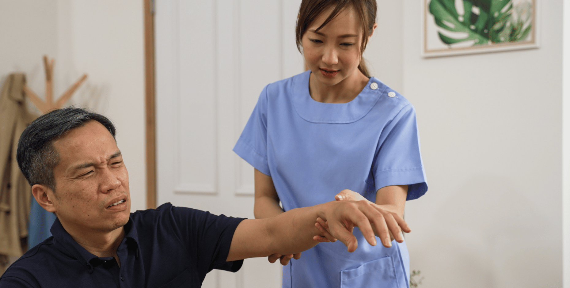 A physiotherapist treating an ageing male