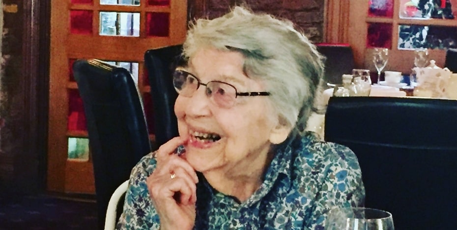 Nan Morrison sitting at a dining table smiling