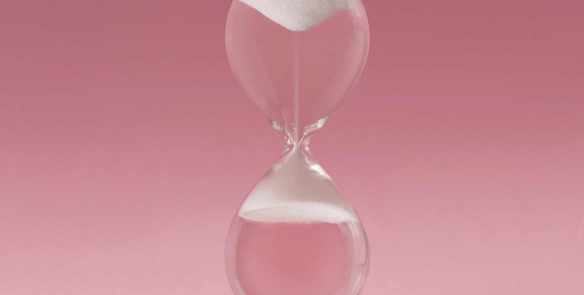 Hourglass on a soft pink background