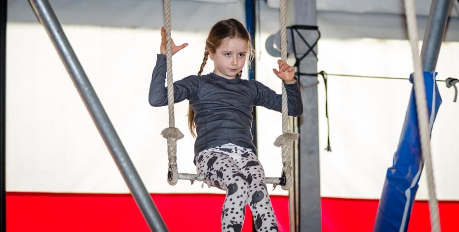 A girl swinging on a trapeze