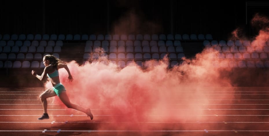 The image shows a running woman with a cloud of red smoke behind her. 