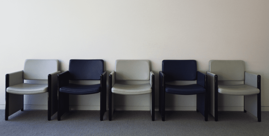 A set of empty chairs in a waiting room.