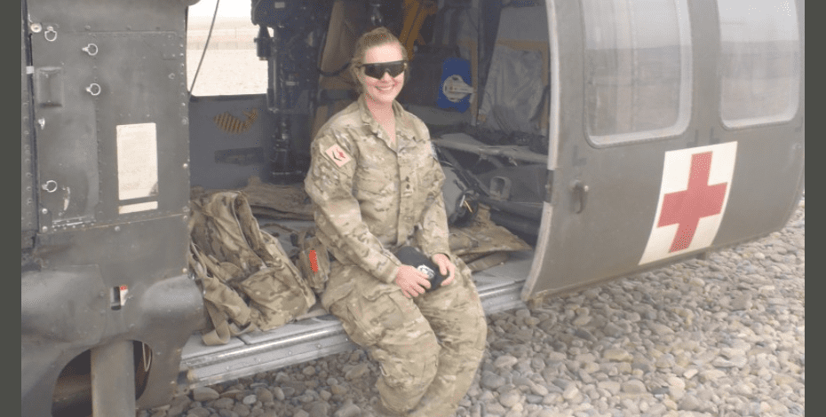 Caitlin wearing her Army fatigues and sitting in accommodation in Papua New Guinea.