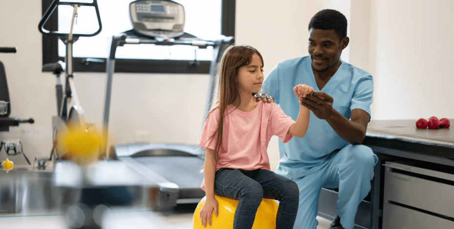 Image of a physiotherapist helping a young patient