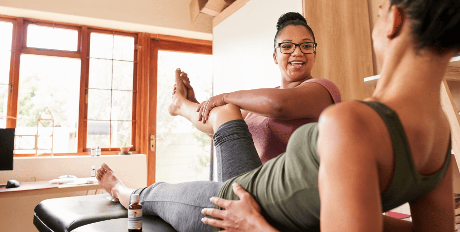 A patient having her leg raised by a physio