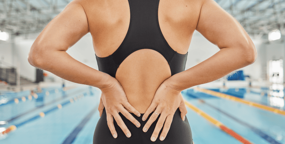 Swimmer clutching her lower back