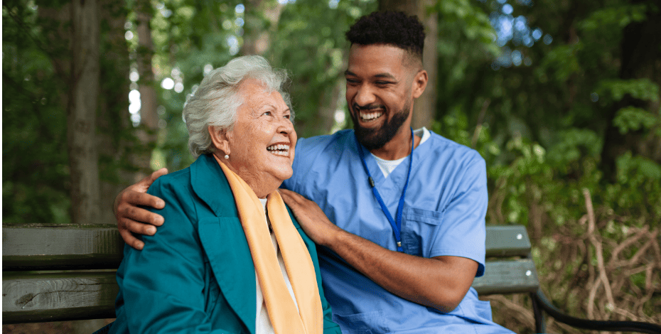 Elderly lady and health practitioner sitting on a bench