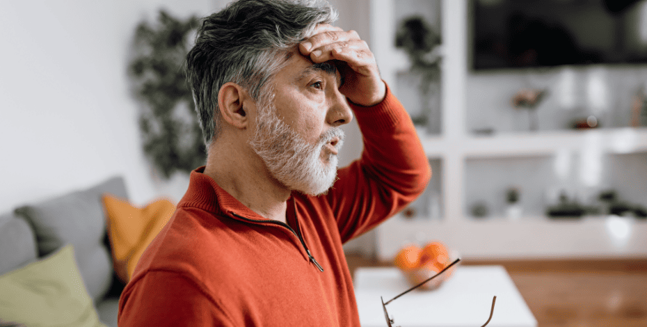 A man touching his forehead in pain
