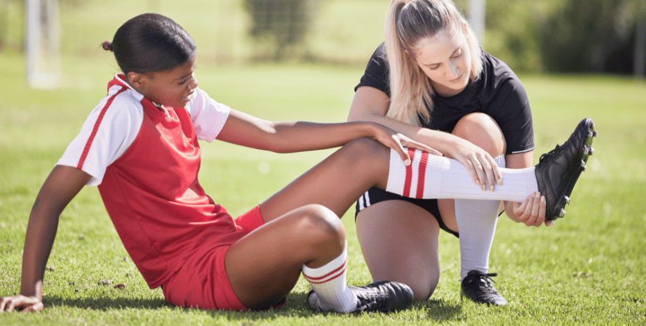 A physiotherapist helps an injured athlete.