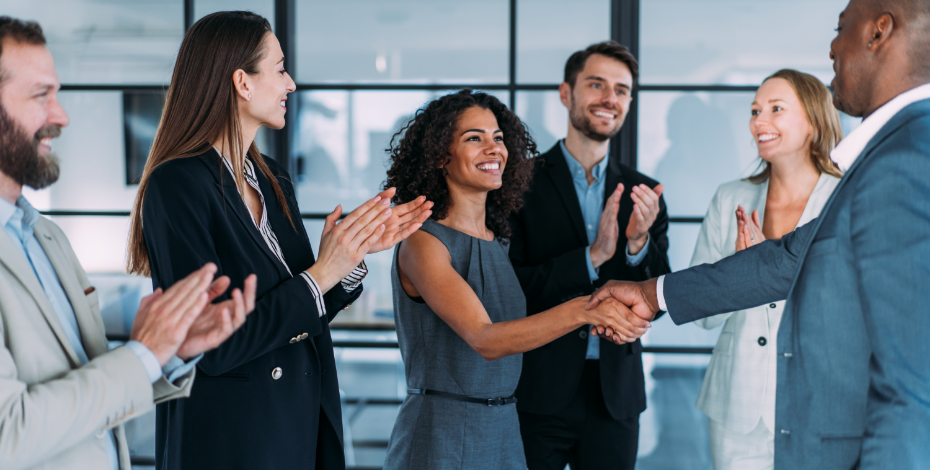 A woman shaking hands as she joins a new team. 