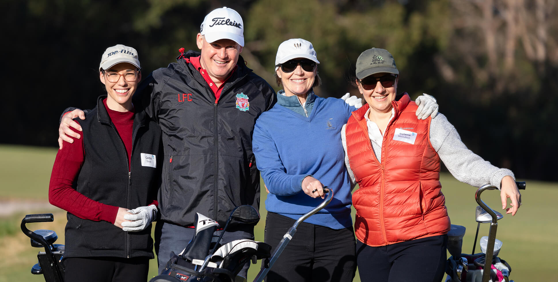 4 golfers shoulder to shoulder