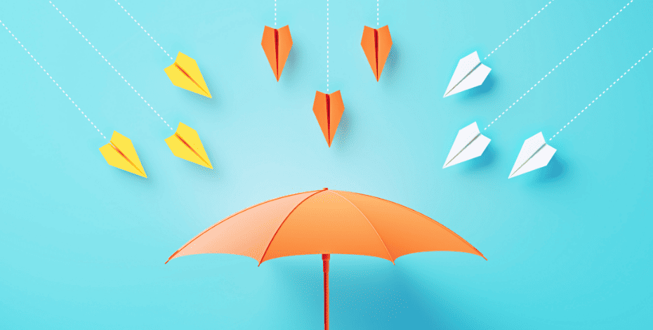 An umbrella with paper planes flying at it