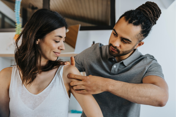 man looking at female arm