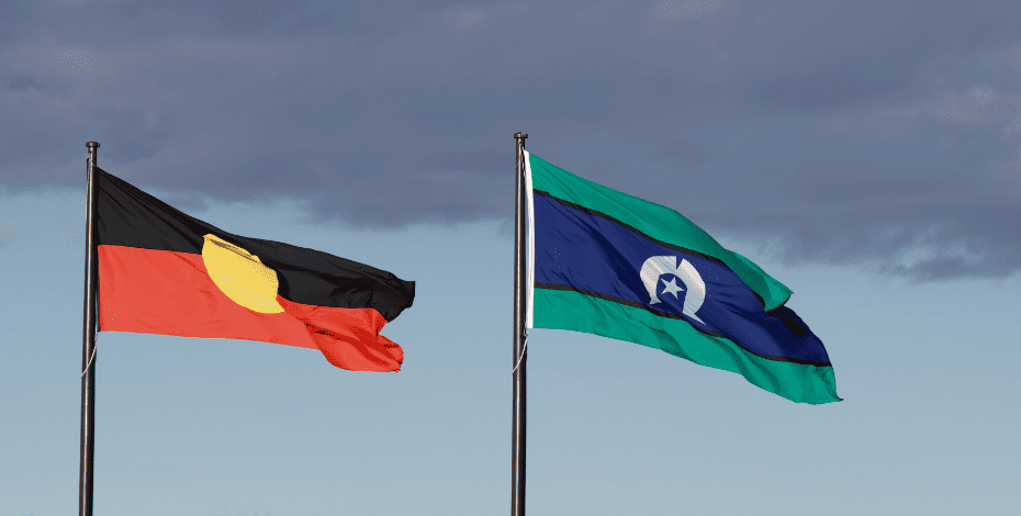 Two flags flying together, one is the Aboriginal flag and the other is a Torres Strait Island flag.