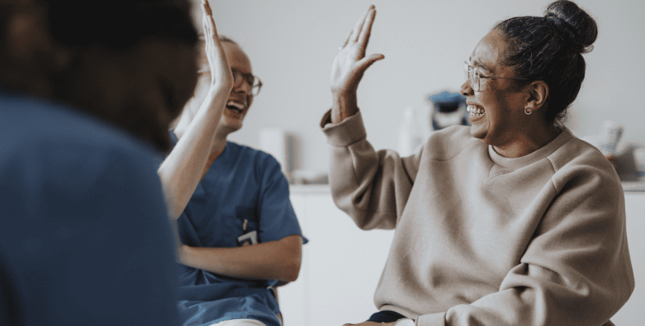 Two health practitioners high-fiving