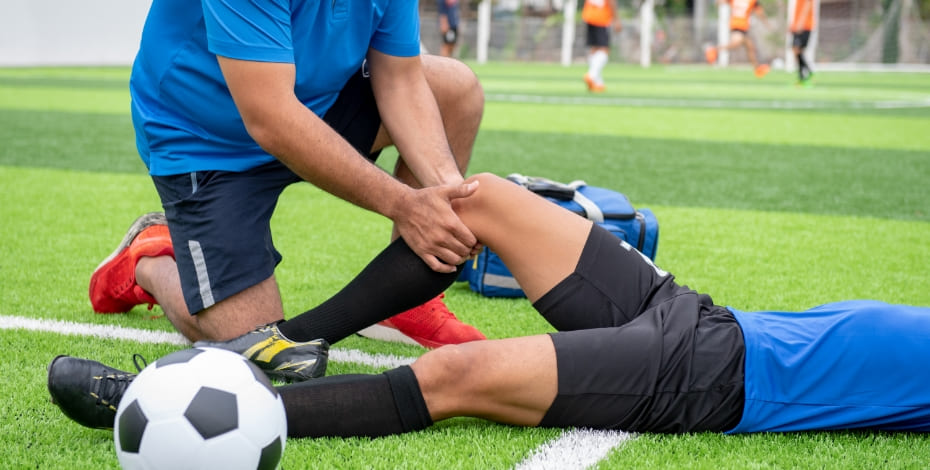 Volunteer physio helping a player during a game