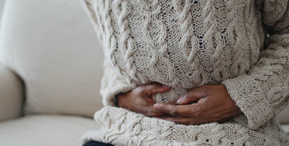Person clutching their abdomen in pain.