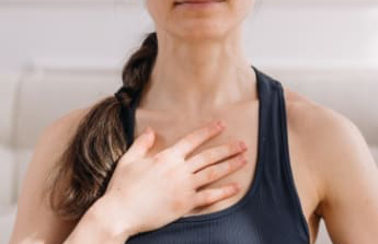 Woman clutching her chest.