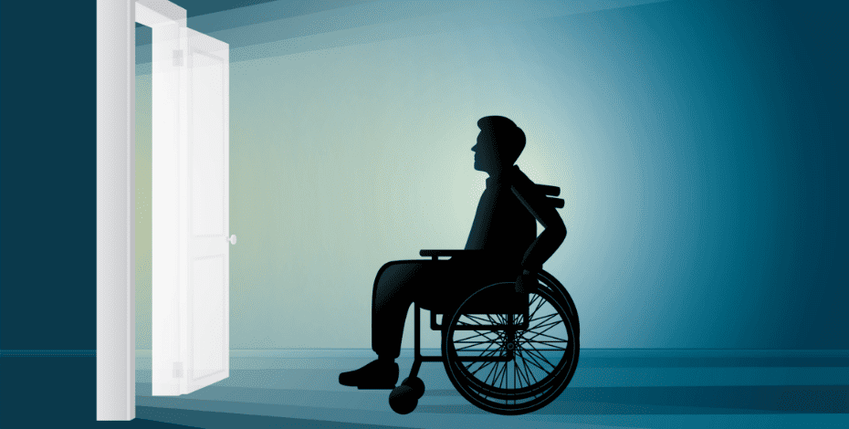 A man in a wheelchair looks through an open door