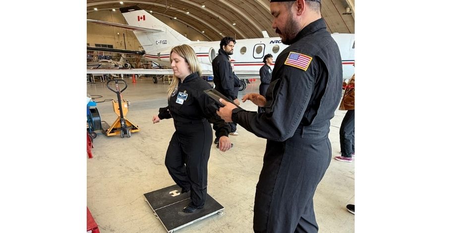 A man and woman are measuring the woman's ability to balance. 