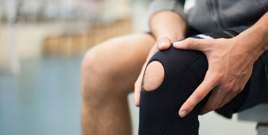 A man clutching his knee 