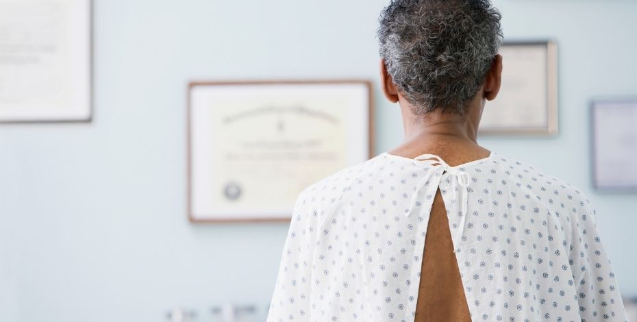Person in a hospital gown waiting in a doctor's office