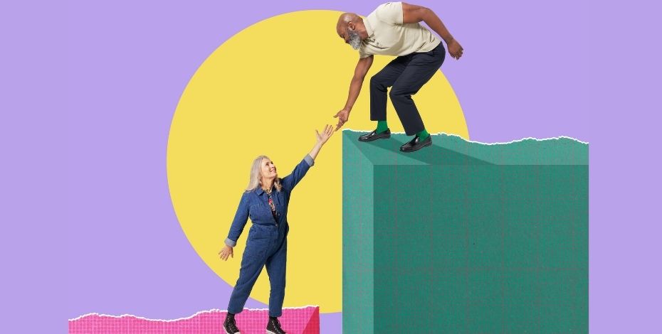 A man reaching down to help a woman up. 