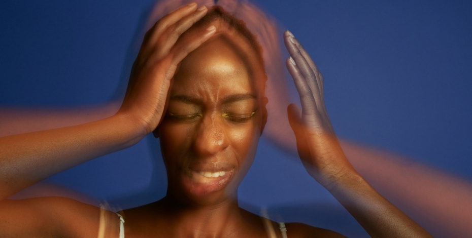 Woman clutching her head in pain.