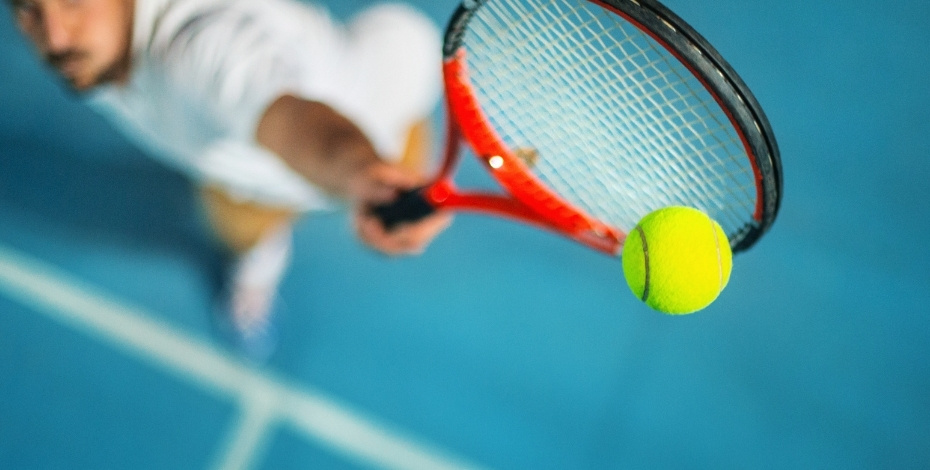 A tennis player gets ready to serve a tennis ball in this artistic impression.