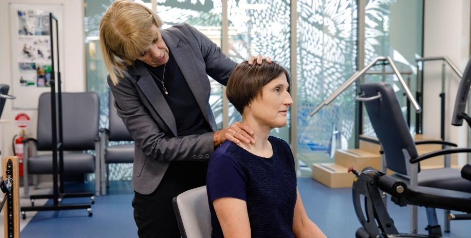Professor Michele Sterling works with a patient. 
