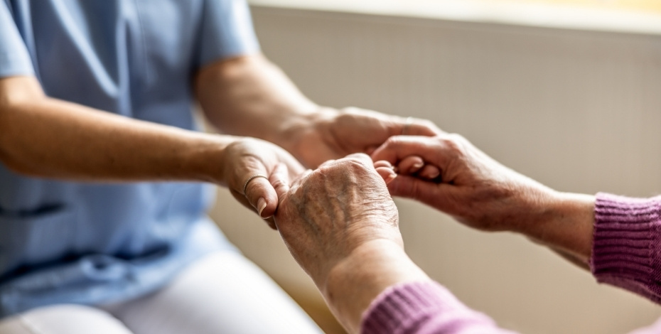 A health professional holding a patient's hands