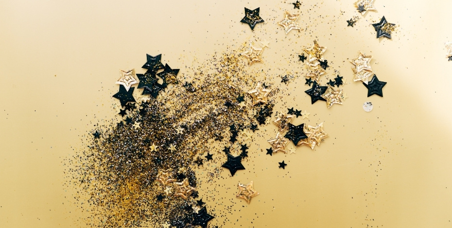 Stars bursting over a golden background 